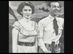 an old black and white photo of a man and woman standing next to each other