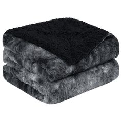 two blankets are stacked on top of each other, one black and the other grey