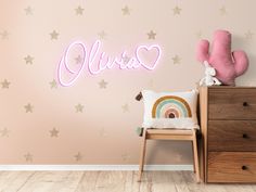 a pink neon sign that says aurora with stars on the wall next to a chair