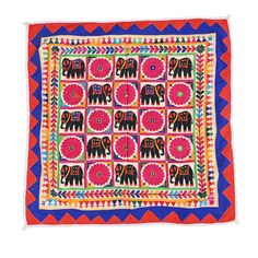 an elephant and flower design on a red, blue, yellow and orange square rug