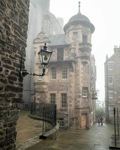 an old stone building on a rainy day