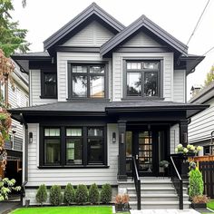 a white house with black trim and windows