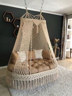 a hammock bed hanging from the ceiling in a living room