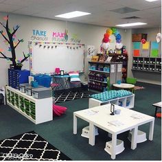 a classroom with tables, chairs and desks in the center is decorated with colorful decorations