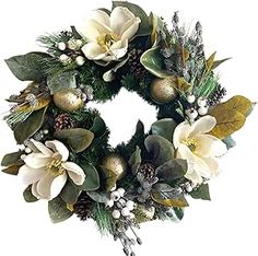 a christmas wreath with white flowers and greenery