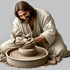 a statue of jesus holding a baby in front of a pottery wheel with sand around it