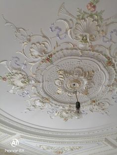 the ceiling is decorated with white and pink flowers, which are embellished in intricate designs