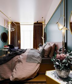 a large bed sitting next to a window in a bedroom under a gold framed mirror