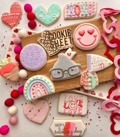 decorated cookies are laying on a cutting board