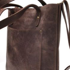 Take your accessories with comfort in our Dark Brown Leather Tote Bag. This bag is best for daily use, as it is easy to carry. You can wear its soft leather straps over your shoulder, keeping all your necessary items with you. This leather tote bag has a sleek, elegant design. It makes any regular outfit unique. Made of Cowhide leather, this bag lasts longer than ordinary tote bags and offers a touch of sophistication. This fascinating design and a good space make it the best bag for daily use. Everyday Satchel With Leather Strap And Tote Shape, Double Handle Shoulder Bag With Leather Strap For Travel, Travel Shoulder Bag With Double Handle And Leather Strap, Everyday Leather Strap Tote Shoulder Bag, Everyday Bags With Leather Strap And Double Handle, Leather Bags With Strap For On-the-go, Everyday Bags With Double Handle And Leather Strap, Everyday Soft Leather Shoulder Backpack, Leather Bags With Leather Strap For Everyday Use