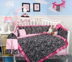 a baby bed with zebra print and pink trim