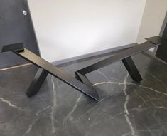 a metal bench sitting on top of a gray floor