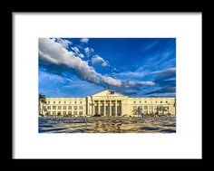 an old building with clouds in the background