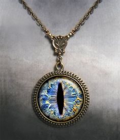 "Frost Dragon Eye Steampunk necklace (Listing 94) Amaze your friends at your next RuneScape or D&D session with this colorful Frost Dragon Eye necklace! It's been set into an Art Nouveau styled necklace for a unique bit of Victorian Steampunk vibe. We have 5 chain length available at checkout (18\", 21\", 24\", 27\" or 30\") and custom lengths are available upon request. Pendant measures 1-3/16\" across (30mm) and the artwork is covered by a crystal clear, domed glass cabochon which protects Collectible Metal Jewelry With Dragon Design, Adjustable Fantasy Necklaces For Fantasy Events, Adjustable Fantasy Necklace For Fantasy Events, Dragon Design Metal Jewelry, Round Metal Jewelry With Dragon Design, Metal Dragon Design Jewelry Gift, Dragon Design Round Pendant Necklace As A Gift, Dragon Design Jewelry For Gift, Dragon Design Round Pendant Necklace For Gift