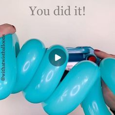 a person is holding a blue object with the words you did it