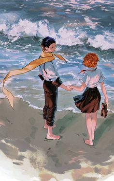 two people standing on the beach holding hands