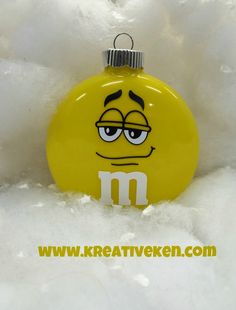 a yellow ornament with an emoticive face on it's side