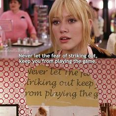 a woman sitting at a table in front of a sign that says never let the fear of striking out, keep you from playing the game