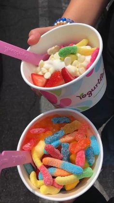 two buckets filled with different colored candies