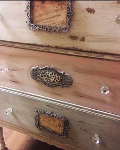 an old dresser is painted white and has ornate knobs on the drawer pulls, which are decorated with leopard print