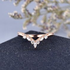 a rose gold wedding ring with three pear shaped diamonds