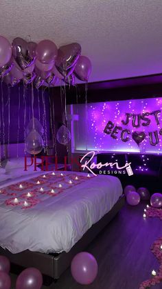 balloons and streamers fill the air above a bed in a room with purple lighting