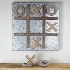 a wooden table topped with an xo sign and two rolls of tape next to it