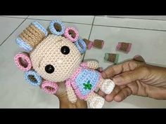 a hand holding a small crocheted stuffed animal