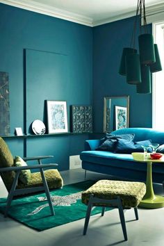 a living room with blue walls and green furniture