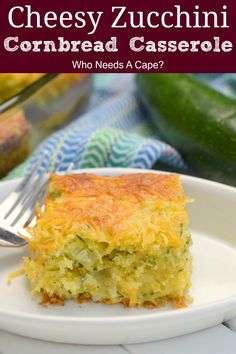 a piece of cheesy zucchini cornbread casserole on a plate with a fork