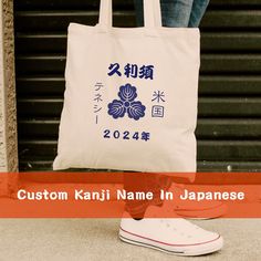 a person standing next to a bag with the words custom kanji name in japanese