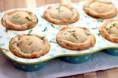 a tray filled with mini pies sitting on top of a table