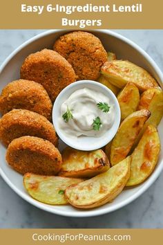 a white bowl filled with fried vegetables and dipping sauce on top of the food in it