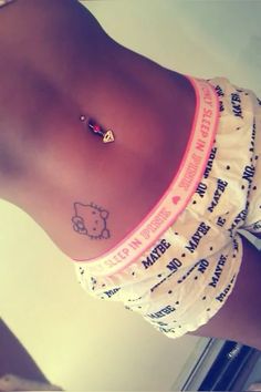 a woman with a hello kitty tattoo on her stomach