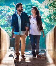 a man and woman walking down a walkway