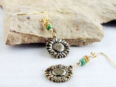 I created these delightful drop earrings in the colors of a golden autumn sunflower, with Picasso seed beads in natural and green, from which I have suspended double-sided antique gold plated sunflower charms made in the USA. The French hook ear wires are gold tone plated (nickel free) and include earring backs. These earrings measures 1 3/4 inches from the top of the earwire to the bottom of the sunflower. This is a great length as they are long enough to be seen but are still lightweight. The Sunflower Jewelry, Sunflower Gifts, Sunflower Earrings, Chic Earrings, Beaded Drop Earrings, Boho Bohemian, Rustic Chic, Earring Backs, Antique Gold