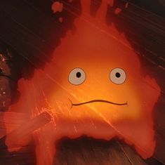 an animated image of a fire with eyes and mouth