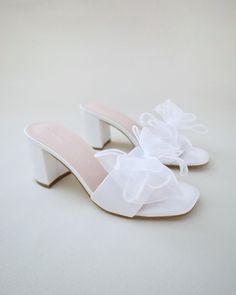 "Classic satin slip on block heel sandals accented with oversized layered organza bow for a sweet and romantic look. Simple and easy wear for bridal wear, bridesmaids, holiday party, wedding parties, and any special occasions.  DETAILS: HEEL HEIGHT: 2.5 Inches COLORS AVAILABLE: White & Ivory UPPER: Synthetic upper and lining MATERIALS: Manmade outsole STYLE NAME: VERONA Not sure of which size to purchase? Shoes measurements are as follow: (Please note measurements taken the length of inside of s