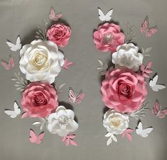 paper flowers and butterflies are arranged on a gray background with pink, white and grey accents