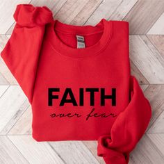 Keep warm and comfortable in this Faith Over Fear Sweatshirt. This cool Christian sweatshirt is soft, stylish, and sure to keep you warm in the colder months. It's versatile to wear for a day outdoors, heading to the gym, or a lazy day watching movies on the couch. Wearing Christian hoodies and sweatshirts can be a subtle way to express your faith and create conversations with anyone and be a gentle reminder to encourage you in any season. They can also spread encouraging words of faith everywhe Comfortable Winter Crew Sweatshirt, Relaxed Fit Sweater For Sports In Winter, Winter Fleece Sweats With Letter Print, Winter Sports Sweatshirt With Relaxed Fit, Winter Sports Sweatshirt In Relaxed Fit, Leisure Winter Sweater With Letter Print, Winter Leisure Sweater With Letter Print, Comfortable Winter Sweatshirt For Leisure, Comfortable Winter Leisure Sweatshirt