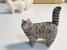 a cat figurine sitting on top of a table