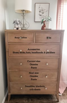 a wooden dresser with lots of drawers and labels on it's front door side