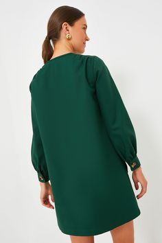 Featuring a full front placket with tortoise shell buttons, long puff sleeves, and a boxy silhouette, the Dark Green Blake Dress is the perfect mod-inspired style. With pockets along the side seams and left chest for extra fun and function, this edgy mini is casual cool while still exuding chic sophistication. Perfect for year round wear, pair this desk to drinks number with heeled sandals for warm days ahead and swap for loafers or boots as the temperature drops. Crew neckline Long puff sleeves Spring Accessories, Plus And Minus, Cocktail Attire, Shell Buttons, Spring Trends, Long Puff Sleeves, Fall Trends, Heeled Sandals, Tortoise Shell