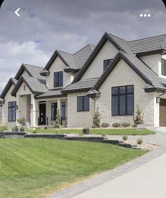 a large house with lots of windows and grass