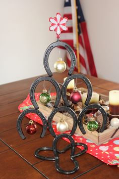 a wooden table topped with ornaments and candles