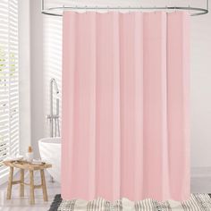 a pink shower curtain in a bathroom