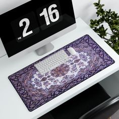 a computer keyboard sitting on top of a desk next to a mouse pad and monitor