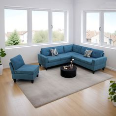 a living room with blue couches and chairs in front of large windows overlooking the city