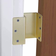 an image of a door handle that is on the side of a wooden door with white trim