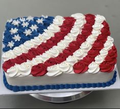 an american flag cake with red, white and blue frosting on it's side